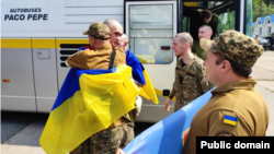 Hugs, Tears, And Flags Greet POWs Returning Home In Russia-Ukraine Swap