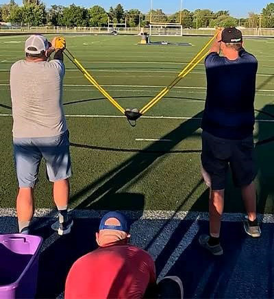  Trio Of Men Breaks Record Using Slingshot To Make Corn-hole Shot From 151 Feet 