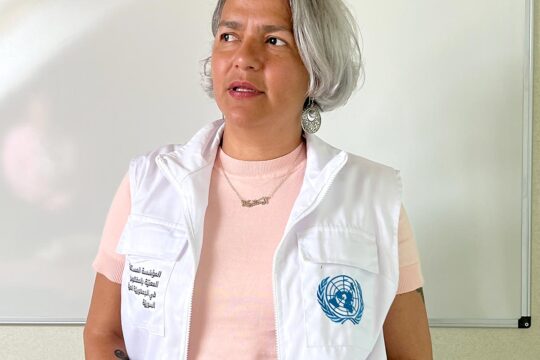 Searching for the missing in Syria. Photo: portrait of Karla Quintana wearing the official IIMP waistcoat in the field.