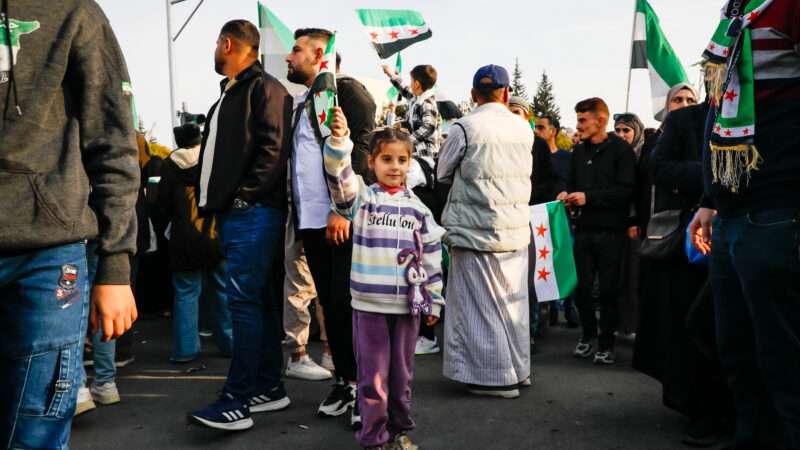 Thousands of Syrians gather in Umayyad Square in central Damascus to celebrate the anniversary of the military operation that led to the fall of Bashar al-Assad's regime. | Mohammad Bashir Aldaher/ZUMAPRESS/Newscom