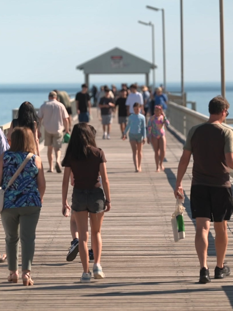 ‘Unusual’ warm weather sees Adelaide residents spending days at beach