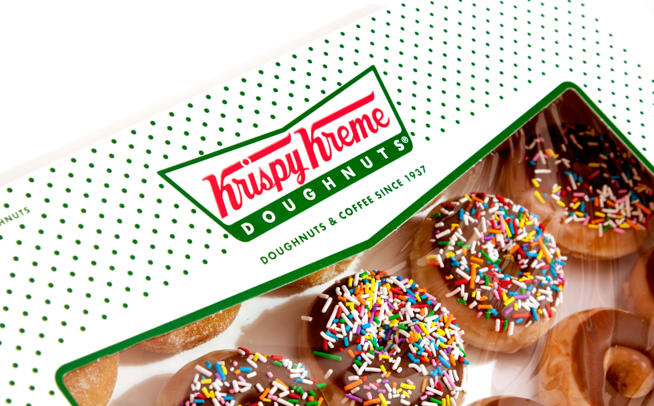 Krispy Kreme cuts losses, but remains in the red
